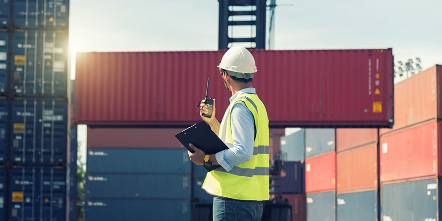 man, containers, hard hat